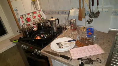 a kitchen counter with pots and pans on a stove at Comfy Bright Apt in OLD TOWN Your Perfect Location in Vilnius