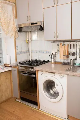a kitchen with a stove and a washing machine at Comfy Bright Apt in OLD TOWN Your Perfect Location in Vilnius
