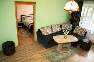 a living room with a couch and a table at Comfy Bright Apt in OLD TOWN Your Perfect Location in Vilnius