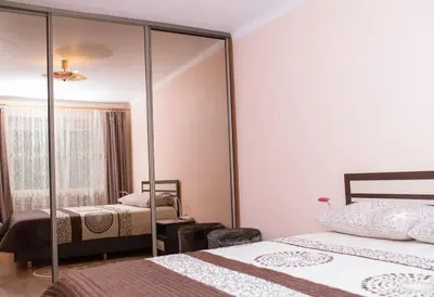 a bedroom with two beds and a mirror at Comfy Bright Apt in OLD TOWN Your Perfect Location in Vilnius