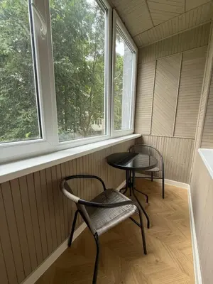 a small room with two chairs and two windows at Naujai įrengti apartamentai Morkus Šiauliai in Šiauliai