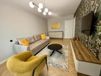 a living room with a couch and a table at Naujai įrengti apartamentai Morkus Šiauliai in Šiauliai