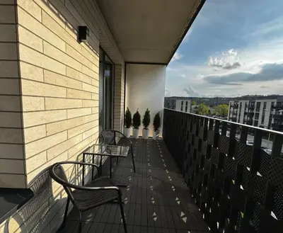 two benches on a balcony with a view of a city at Lazdyneliu Vingis Vilnius 