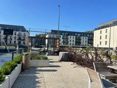 a patio with benches and buildings in a city at Lazdyneliu Vingis Vilnius 
