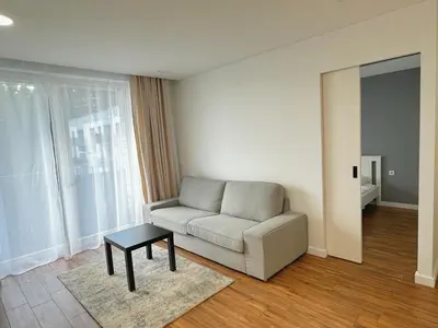 a living room with a couch and a table at Lazdyneliu Vingis Vilnius 