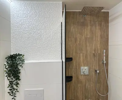 a white refrigerator in a bathroom with a shower at Lazdyneliu Vingis Vilnius 