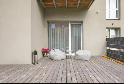 a patio with two bean bags on a wooden deck at Cozy Apartment in Kaunas