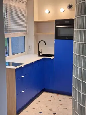 a kitchen with blue cabinets and a sink at Cosy hill in Kaunas