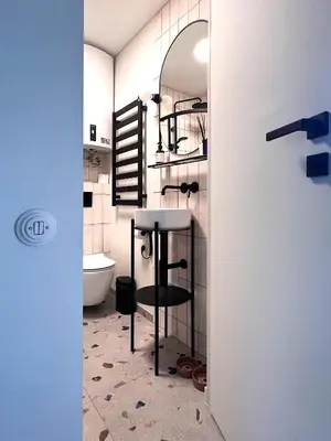 a bathroom with a stool and a table in a room at Cosy hill in Kaunas