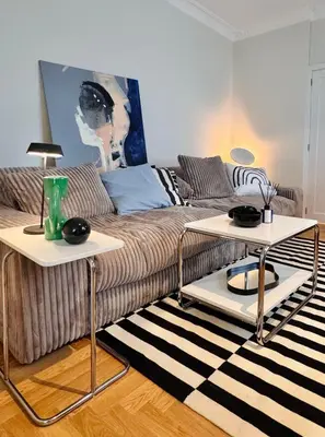 a living room with a couch and two tables at Cosy hill in Kaunas