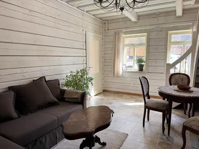 a living room with a couch and a table at Private Trakai Boutique Historical Authentic Karaim Two Floor Apartment House in Trakai