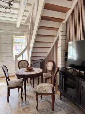 a dining room with a table and chairs and a tv at Private Trakai Boutique Historical Authentic Karaim Two Floor Apartment House in Trakai