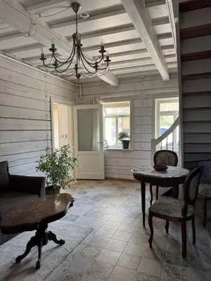 a living room with a table and chairs and a chandelier at Private Trakai Boutique Historical Authentic Karaim Two Floor Apartment House in Trakai