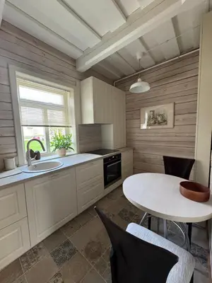 a kitchen with a table and a sink at Private Trakai Boutique Historical Authentic Karaim Two Floor Apartment House in Trakai
