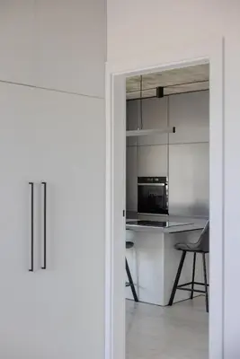 a kitchen with white cabinets and a counter top at Skyline 1 BD Apartment by Domvia in Vilnius
