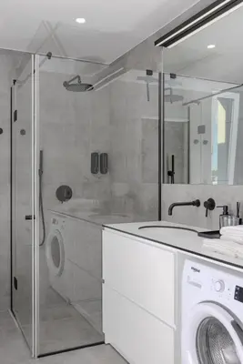 a bathroom with a washing machine and a washer at Skyline 1 BD Apartment by Domvia in Vilnius