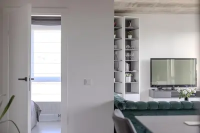 a living room with a couch and a television at Skyline 1 BD Apartment by Domvia in Vilnius