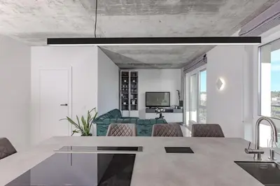 a kitchen and living room with a table and chairs at Skyline 1 BD Apartment by Domvia in Vilnius