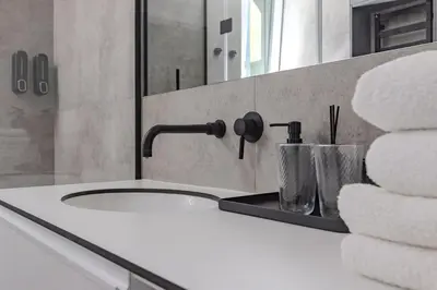 a bathroom with a sink and a mirror and towels at Skyline 1 BD Apartment by Domvia in Vilnius