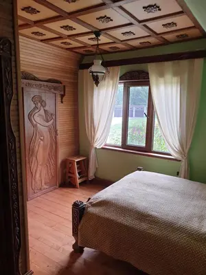 a bedroom with a bed and a large window at Semeniukų Sodyba in Rakantai