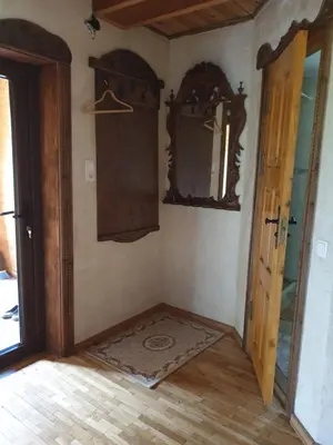a corner of a room with a mirror and a door at Semeniukų Sodyba in Rakantai