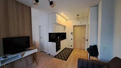 a living room with a flat screen tv and a couch at Vilnius Apartment in Vilnius