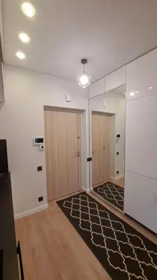 an empty room with two doors and a rug at Vilnius Apartment in Vilnius