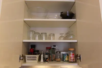 a cupboard filled with lots of glass jars at Warmzy Home near Park with Free Parking in Vilnius