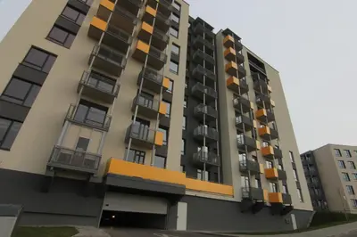 a tall apartment building with balconies on it at Warmzy Home near Park with Free Parking in Vilnius