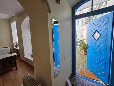 a blue door in a room with a window at Mykoliukas in Vilnius