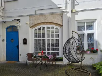 a patio with a table and chairs in front of a house at Mykoliukas in Vilnius
