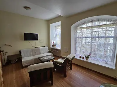 a living room with a couch and a window at Mykoliukas in Vilnius