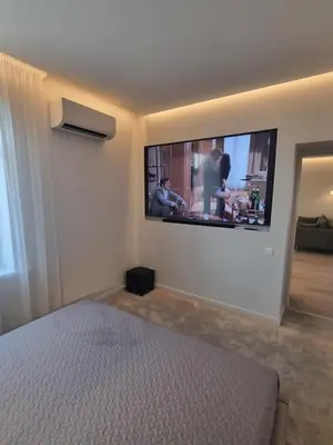 a bedroom with a flat screen tv on the wall at Apartamentai Varpas in Šiauliai