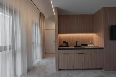 a kitchen with a sink and a counter top at LAJOS Hotel in Birštonas