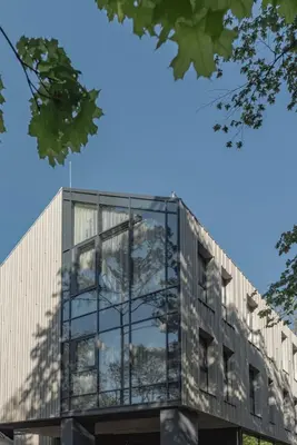 a building with glass windows on the side of it at LAJOS Hotel in Birštonas