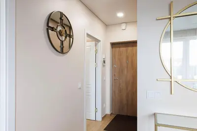 a hallway with a large clock on the wall at Modernus butas prie EŽERO in Vilnius