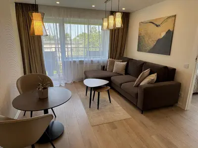 a living room with a couch and a table at Draugystės apartamentai II in Šiauliai