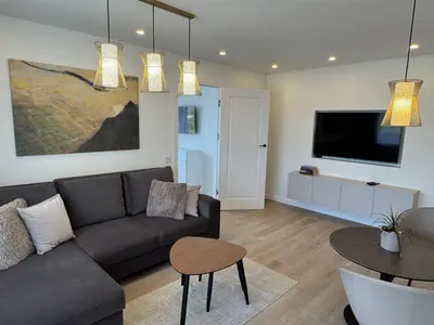 a living room with a couch and a table at Draugystės apartamentai II in Šiauliai