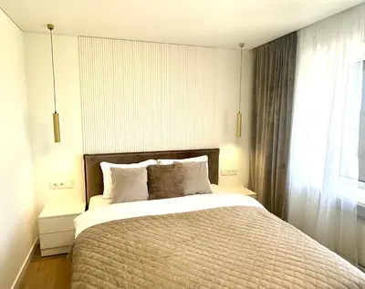 a bedroom with a large bed and a window at Draugystės apartamentai II in Šiauliai