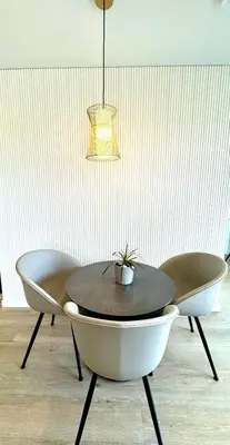 a table with two chairs and a potted plant on it at Draugystės apartamentai II in Šiauliai