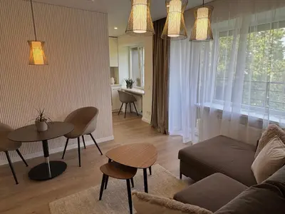 a living room with a couch and a table at Draugystės apartamentai II in Šiauliai