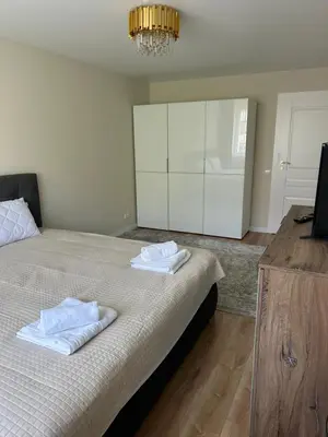 a bedroom with a bed with two towels on it at NESTAa in Druskininkai