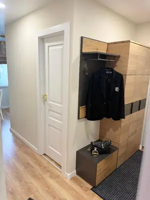 a room with a black shirt hanging on a wall at NESTAa in Druskininkai