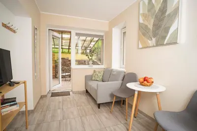 a living room with a couch and a table at Compact and Comfy Apartment on the Greenhill in Kaunas