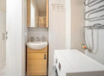 a bathroom with a sink and a toilet in it at Compact and Comfy Apartment on the Greenhill in Kaunas