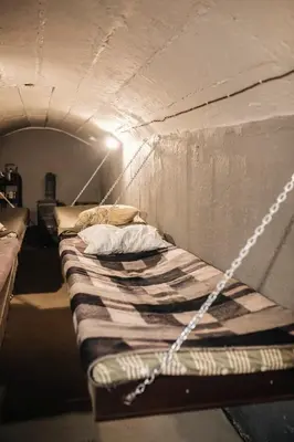 a bed in a room with a chain around it at Pinčiukas Bunkeris in Dagiai