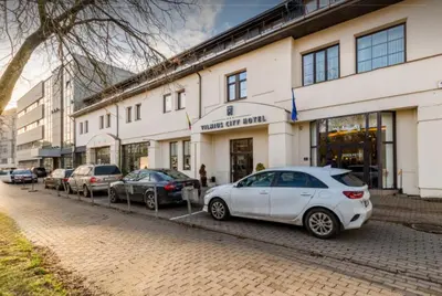 a white car parked in front of a building at Cosy Naujamiescio apartment in Vilnius