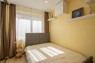 a bedroom with a bed in front of a window at Ramybes Oaze, Nauji stylingi apartamentai in Panevėžys