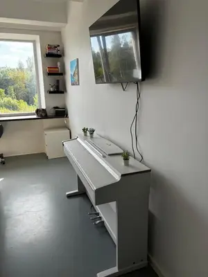 an office with a desk and a window and a computer at Flat-studija in Vilnius