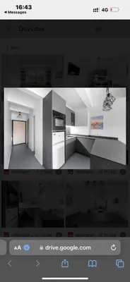 a picture of a kitchen with a picture of a room at Flat-studija in Vilnius